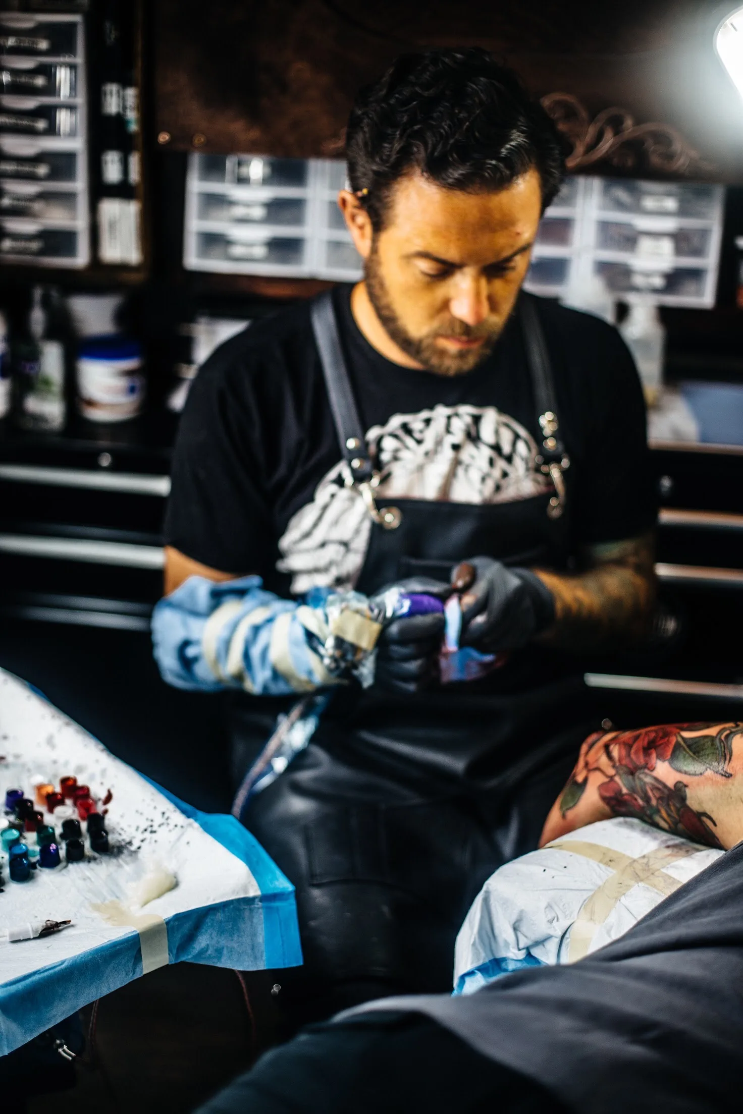 Terry Ribera at work tattooing a client, San Diego