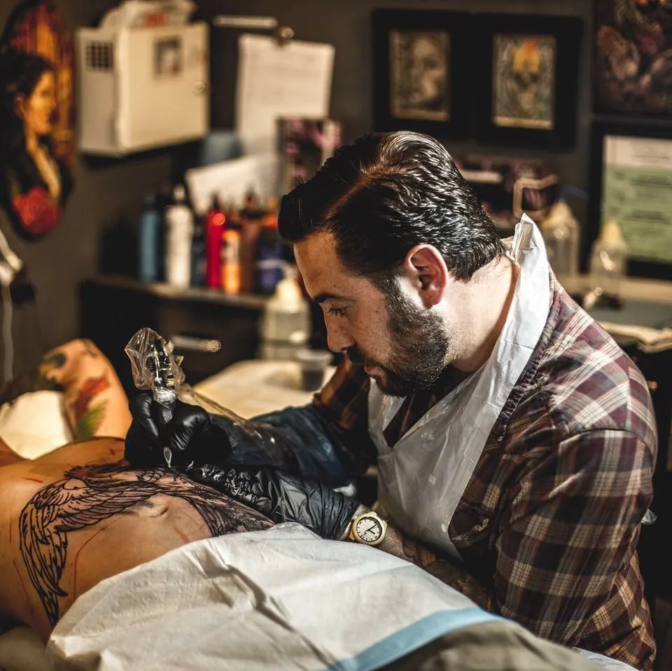 Terry Ribera tattooing a client at Remington Tattoo, San Diego CA