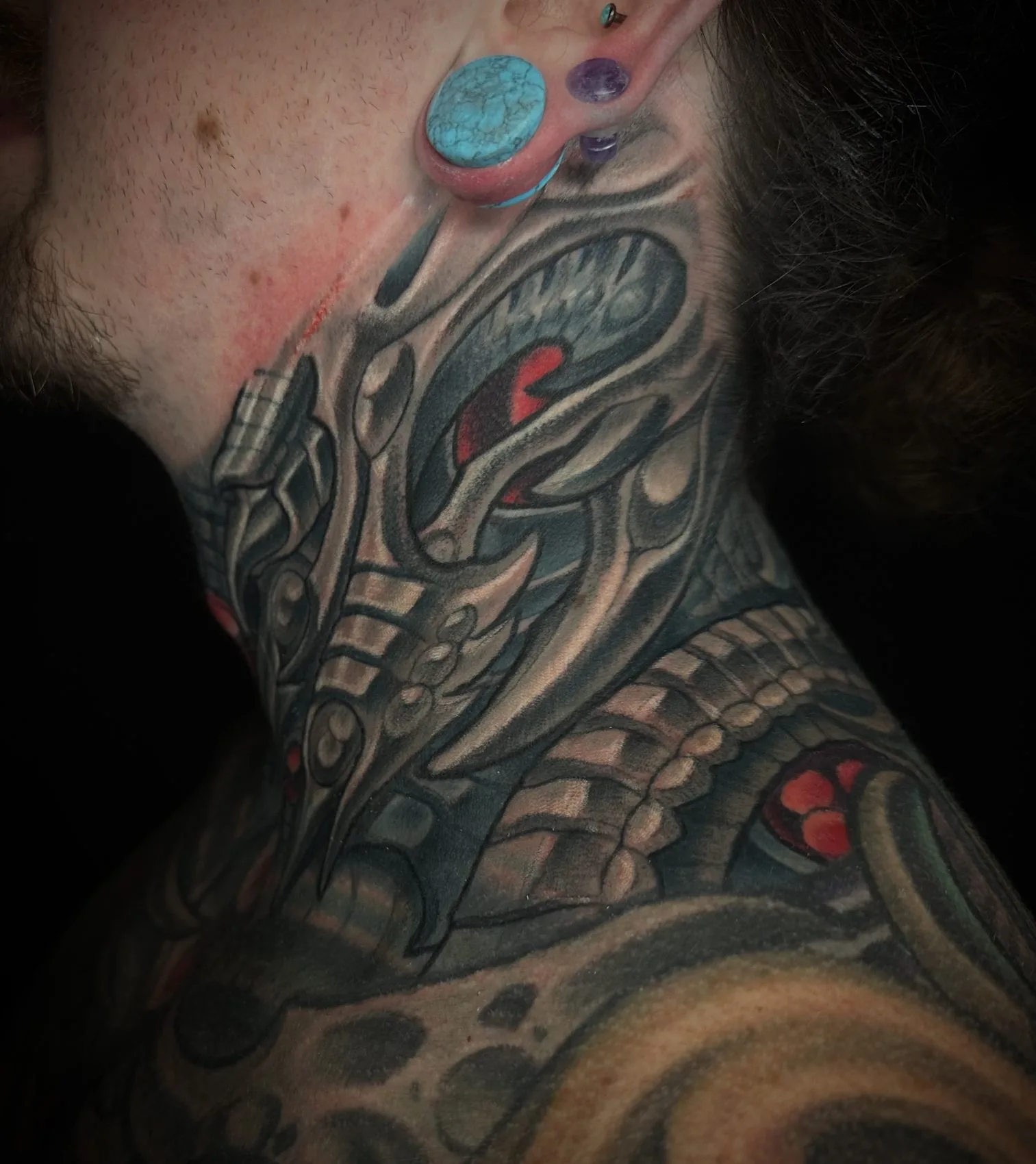 Right side view of the same biomechanical neck tattoo, showing the design continuing around the full circumference by Terry Ribera at Remington Tattoo in San Diego.