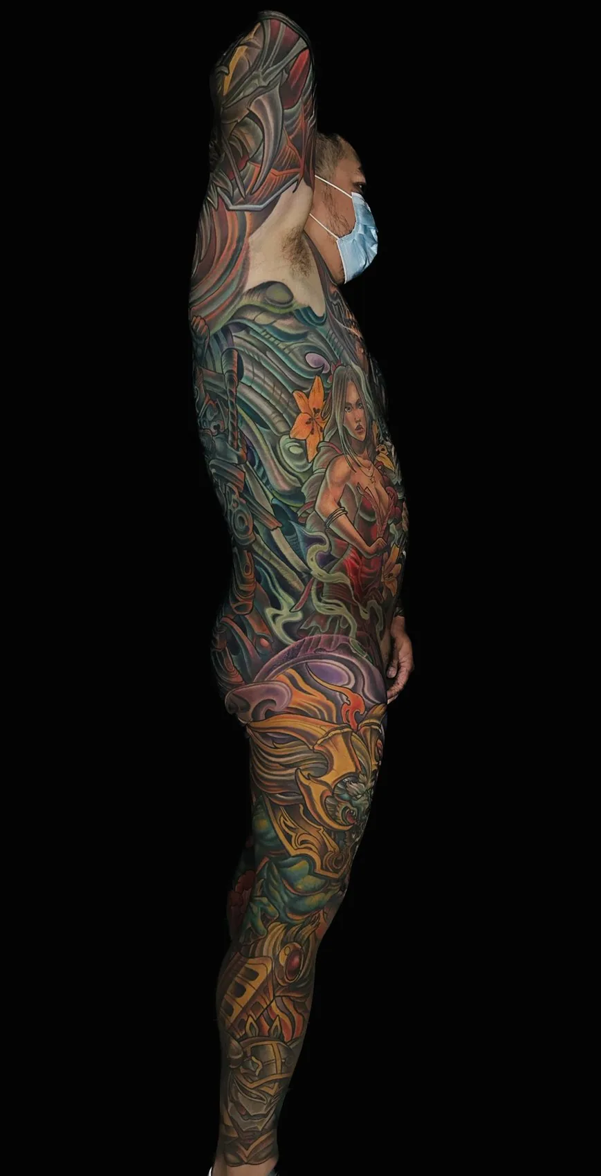 Fantasy illustrative bodysuit tattoo, left profile view showing the design wrapping the side of the body by Terry Ribera at Remington Tattoo in San Diego.