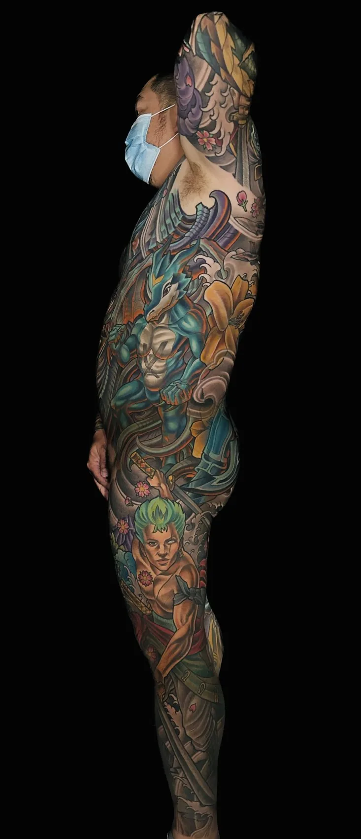 Fantasy illustrative bodysuit tattoo, right profile view showing continuous coverage from shoulder to ankle by Terry Ribera at Remington Tattoo in San Diego.