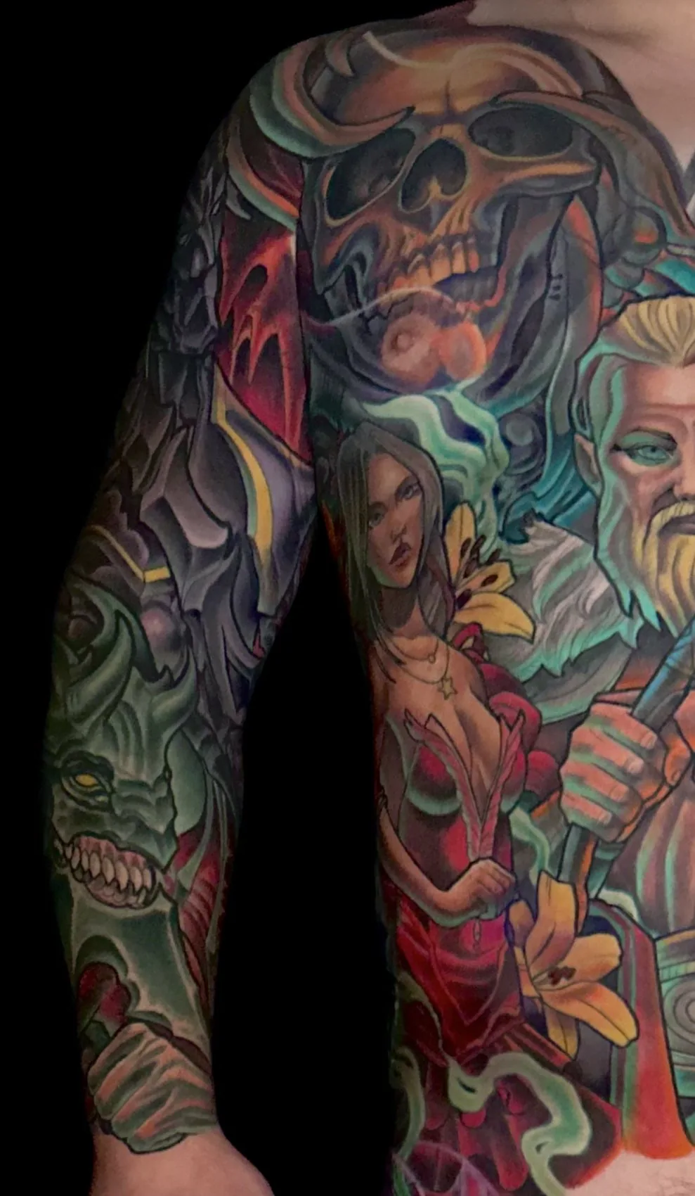 Fantasy illustrative bodysuit tattoo, left arm sleeve and torso detail with a demon and skull by Terry Ribera at Remington Tattoo in San Diego.