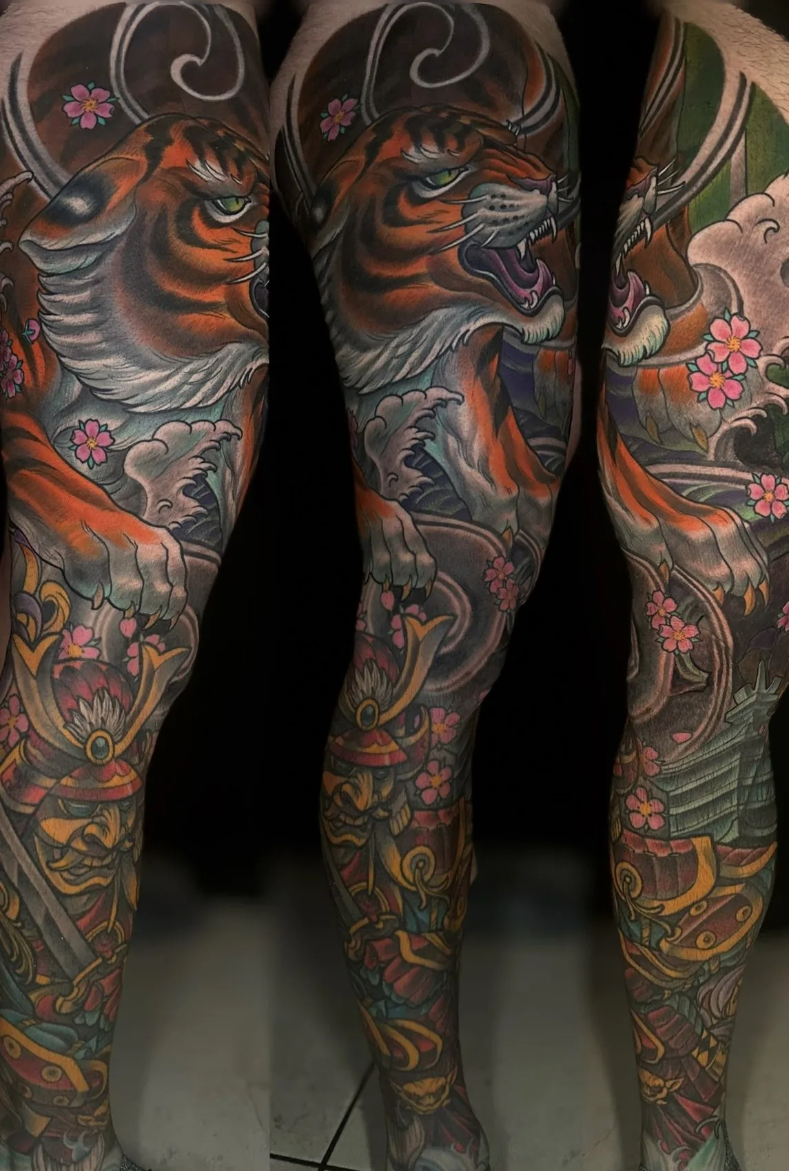 Neo Japanese full color leg sleeve tattoo of a roaring tiger over a samurai warrior with cherry blossoms and waves, shown from three angles by Terry Ribera at Remington Tattoo in San Diego.