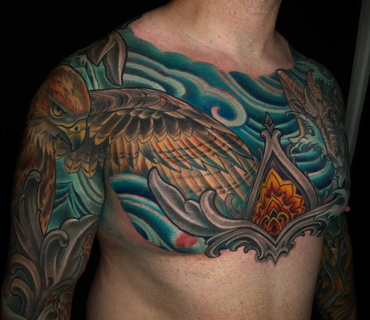 Illustrative wildlife bodysuit tattoo, owl and ornamental chest piece in teal and brown by Terry Ribera at Remington Tattoo in San Diego.