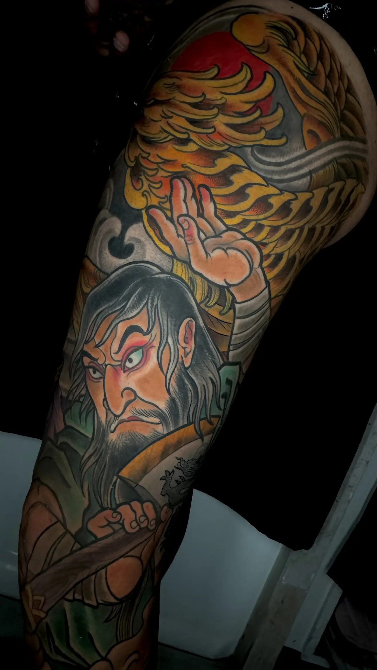 Neo Japanese leg sleeve tattoo with a warrior figure and golden phoenix in full color, by Terry Ribera San Diego