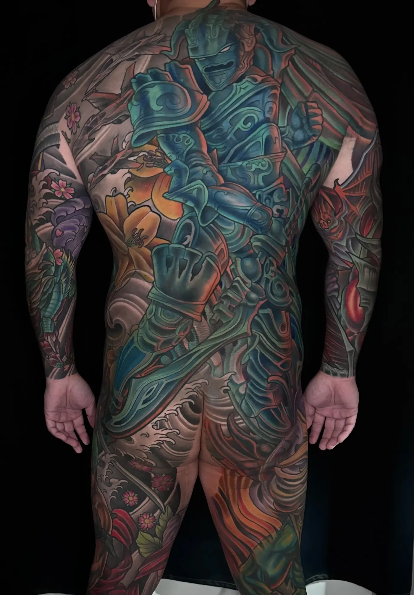 Neo Japanese body suit tattoo, back view, with an armored warrior figure, lilies, and waves across the full back and sleeves, by Terry Ribera San Diego