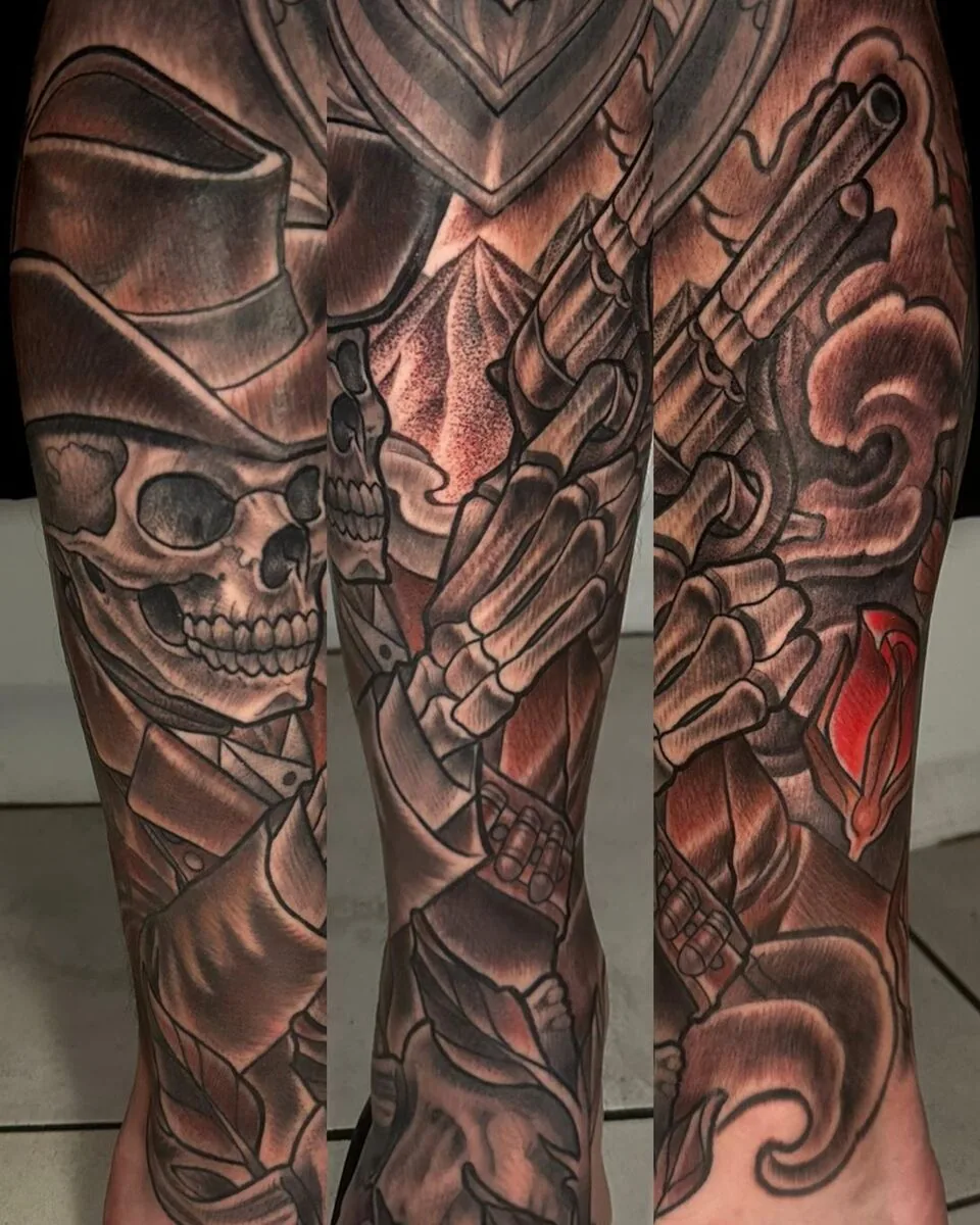 Illustrative black and grey outlaw cowboy skull guns sleeve tattoo by Terry Ribera, San Diego