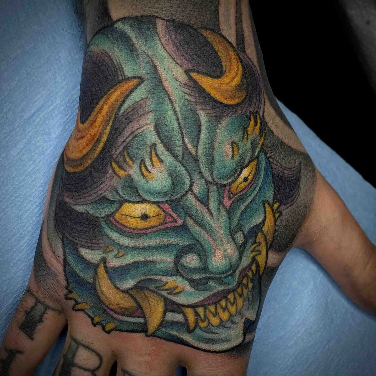 Neo Traditional Hannya mask hand tattoo by Terry Ribera, San Diego
