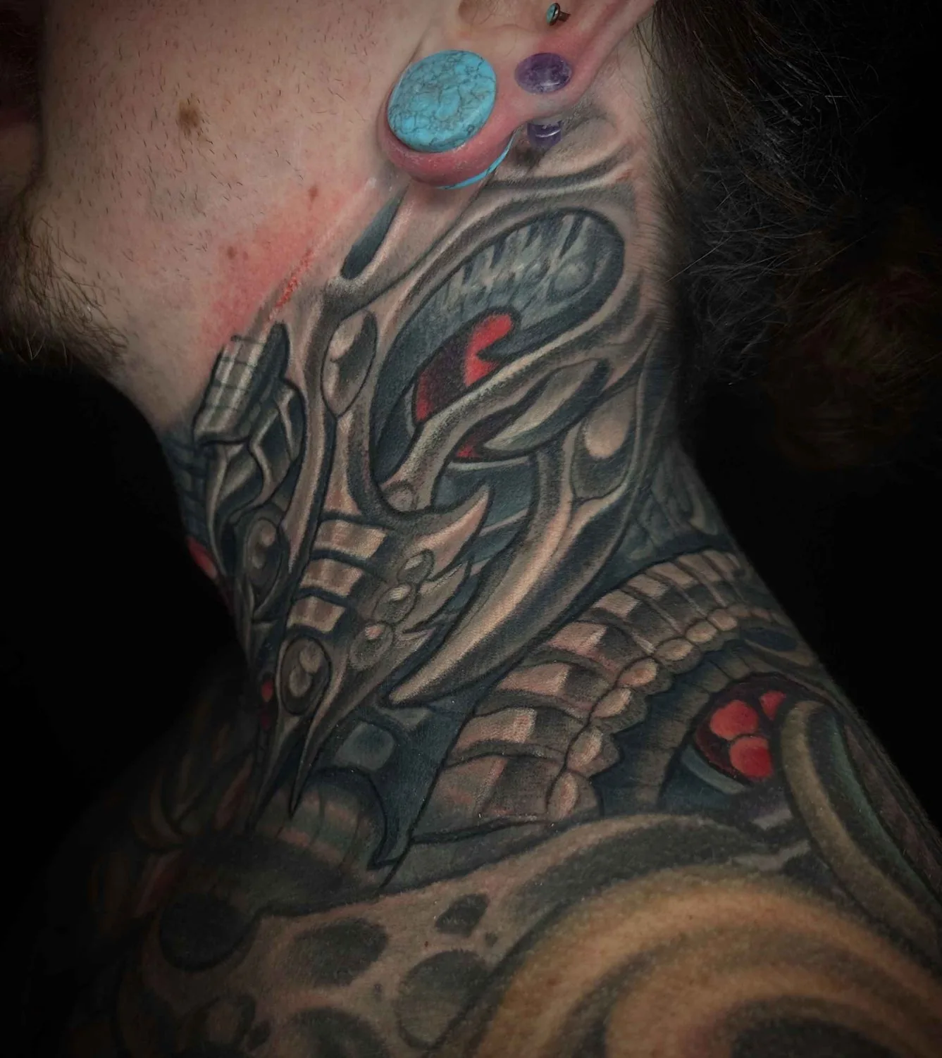 Bio-organic alien neck side view tattoo by Terry Ribera, San Diego