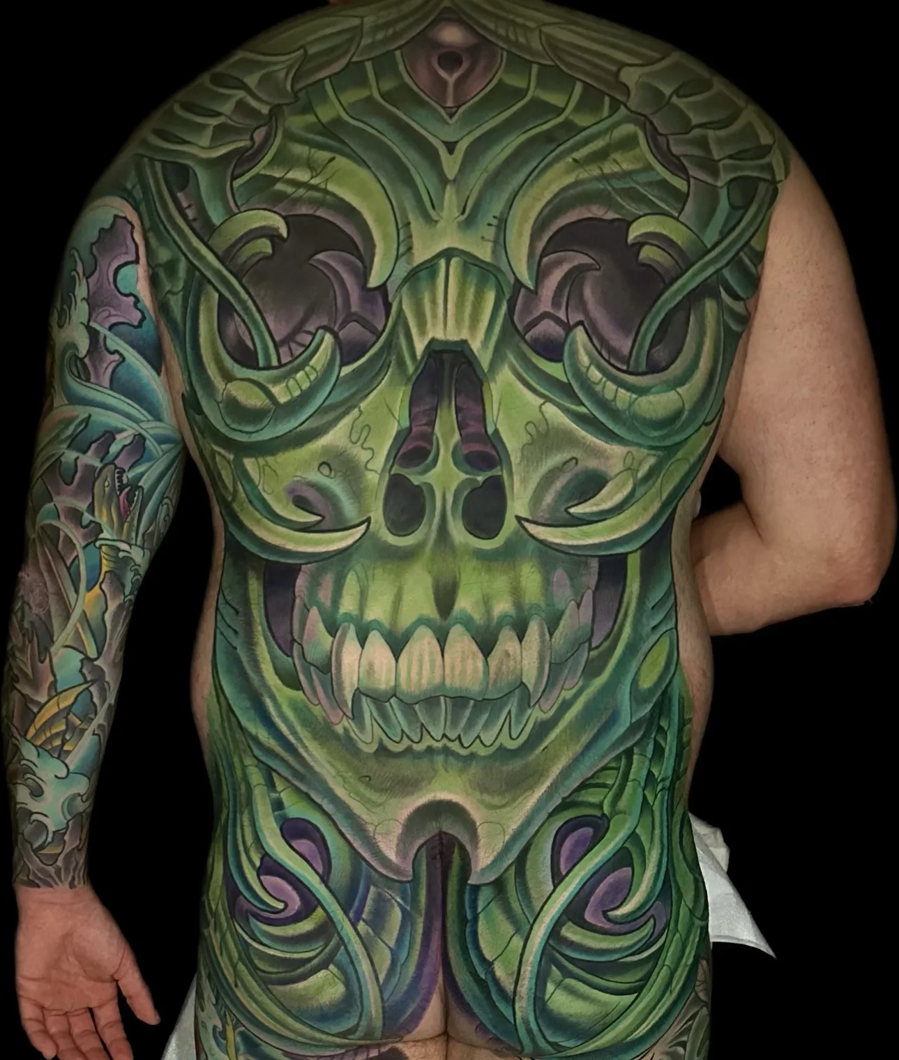 Green biomechanical and bio-organic full back piece tattoo by Terry Ribera, San Diego