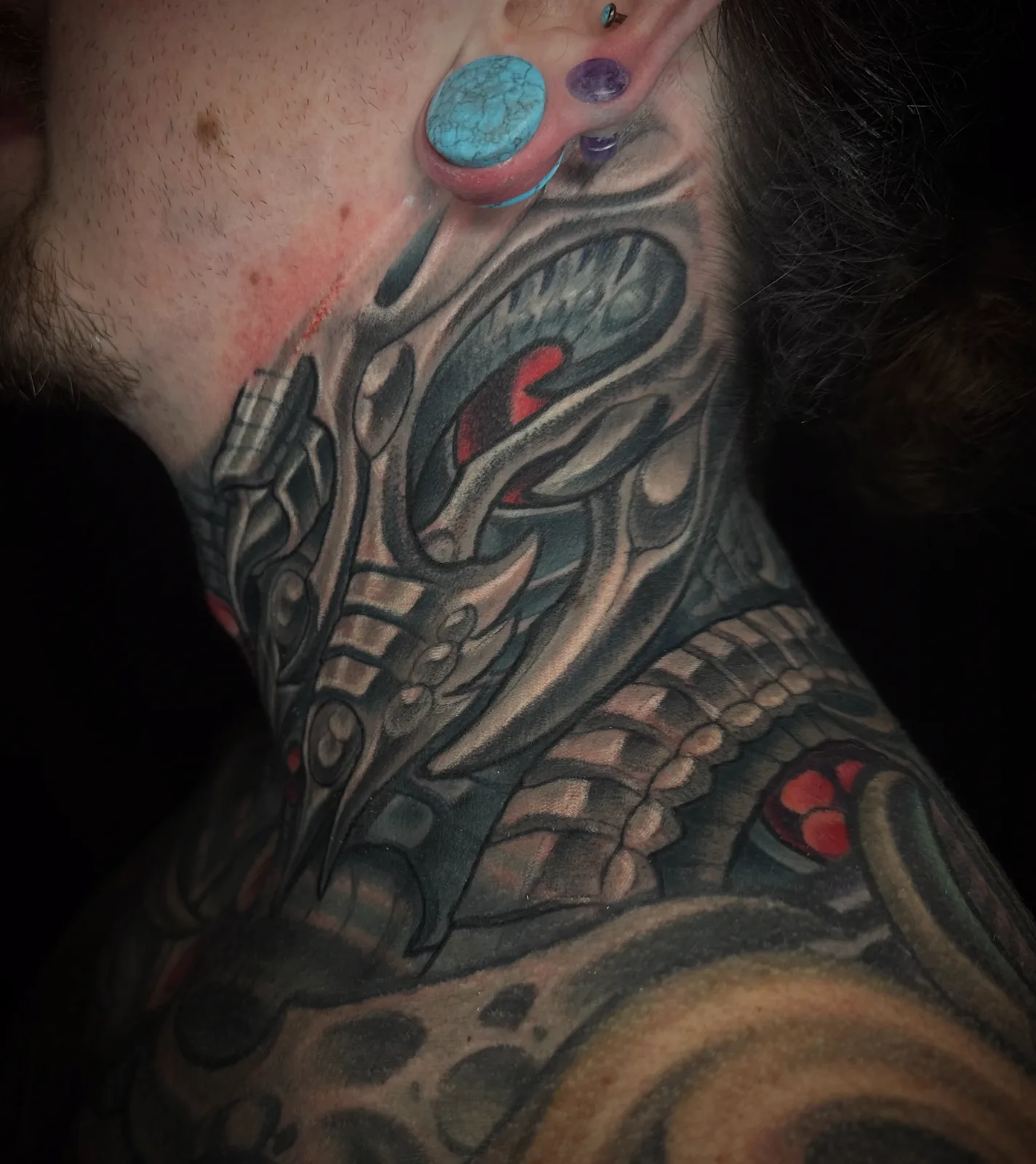 Black and grey biomechanical and bio-organic neck tattoo by Terry Ribera, San Diego