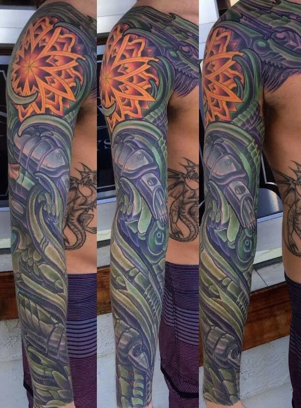 Green and orange biomechanical and bio-organic full sleeve tattoo by Terry Ribera, San Diego